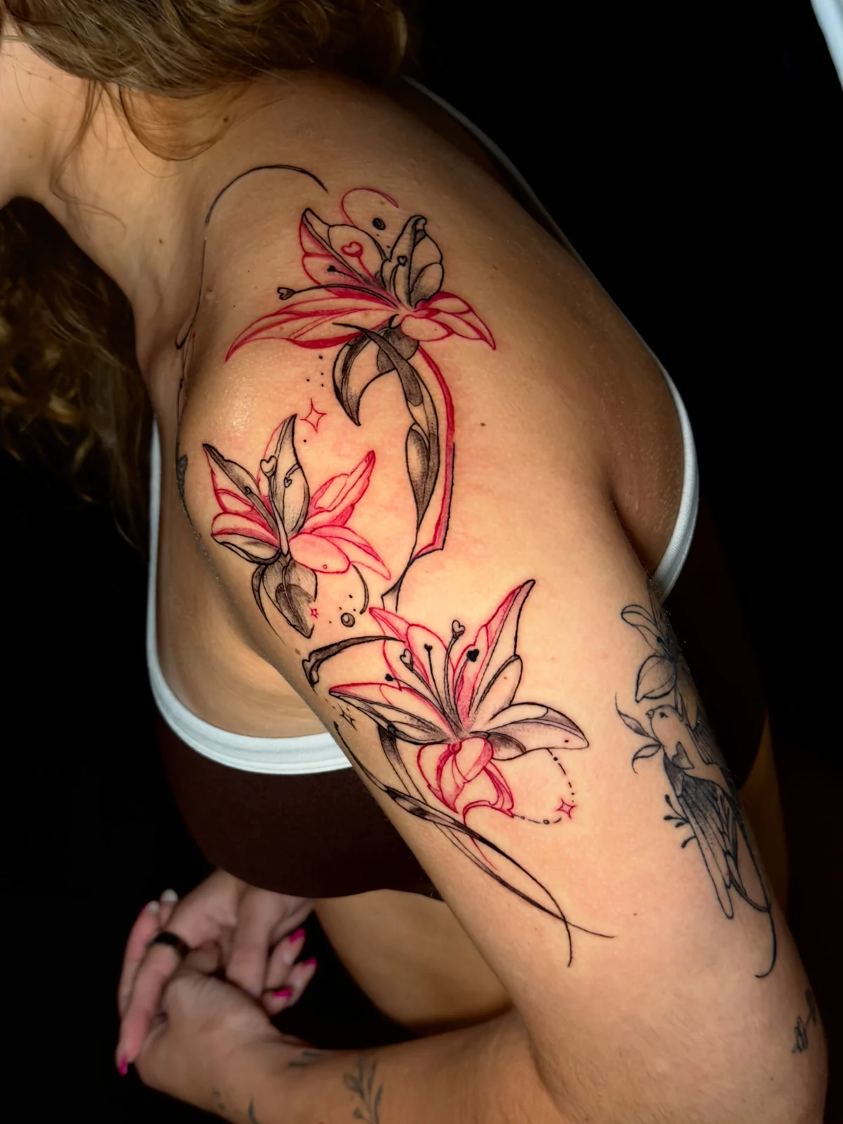 Red and black floral shoulder tattoo by Jeh Goa